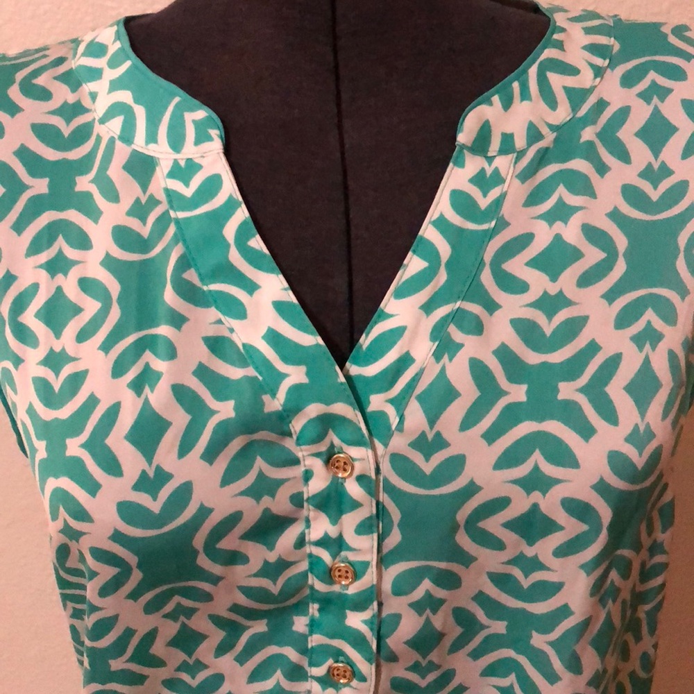 Turquoise/white sleeveless top.